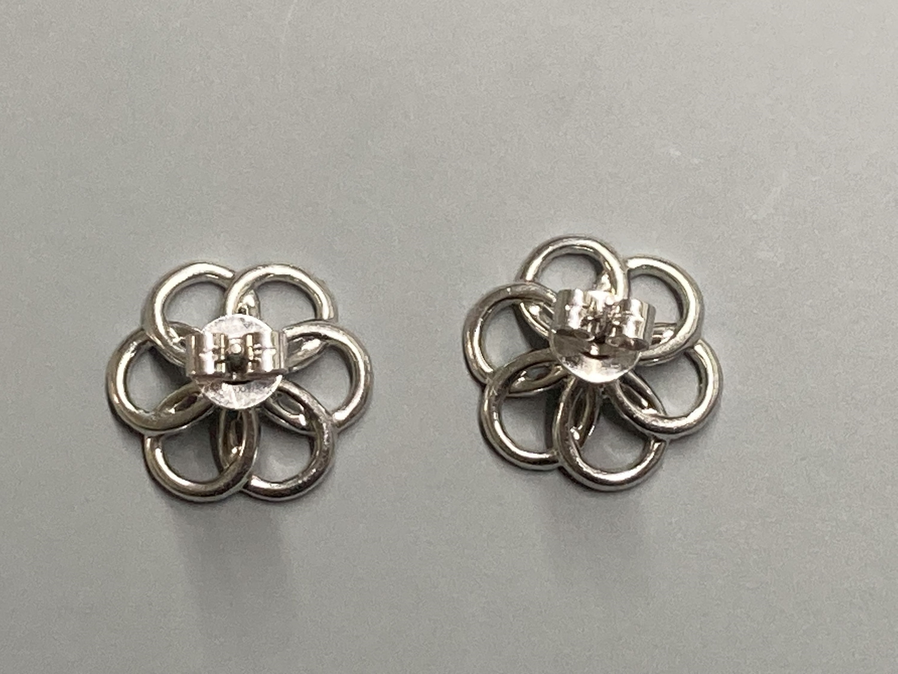 A modern pair of 18ct white gold and diamond cluster set openwork flower head ear studs, diameter 16mm, gross weight 4.4 grams.